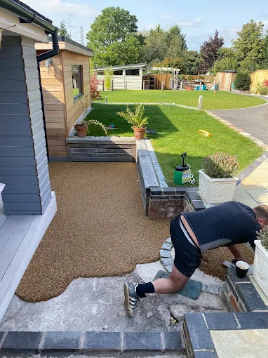 Resin bound garden path being finished by hand at a Redditch home