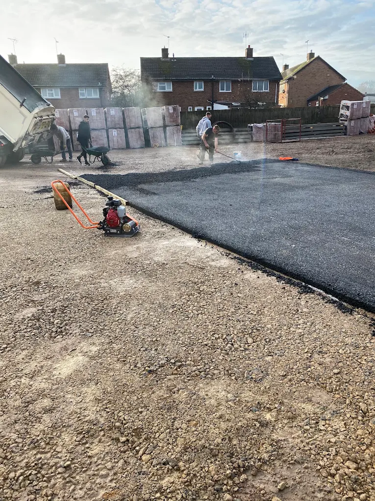 New tarmac being spread and raked on a Redditch driveway