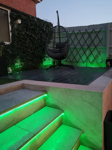 Raised composite deck with LED lit stone steps