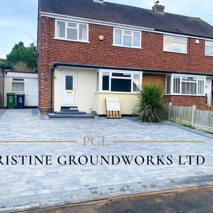 After: grey block paved driveway in front of a semi detached house