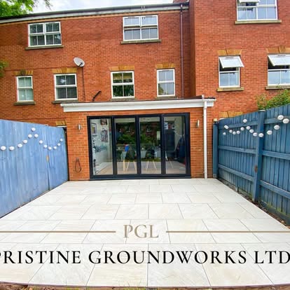 After: light porcelain patio outside bi-fold doors with blue painted fences
