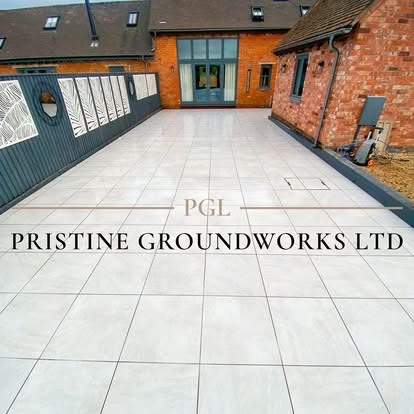 Large light porcelain courtyard outside a converted brick building