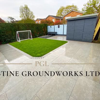 After: porcelain patio beside a curved lawn with a football goal and grey shed
