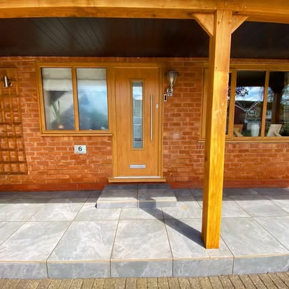 After: porcelain patio under a timber front porch