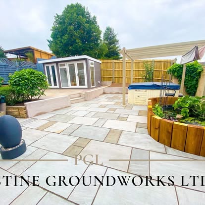 Sandstone patio with raised timber beds in front of a garden room