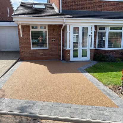 After: golden resin bound driveway with a grey block border in front of a bungalow