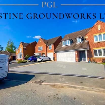 Wide resin driveway in front of a row of detached houses
