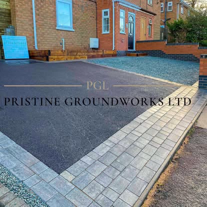 After: tarmac driveway with block edging and a gravel strip beside a garage