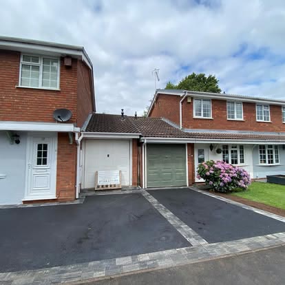 After: two neighbouring tarmac driveways with block borders outside link detached houses