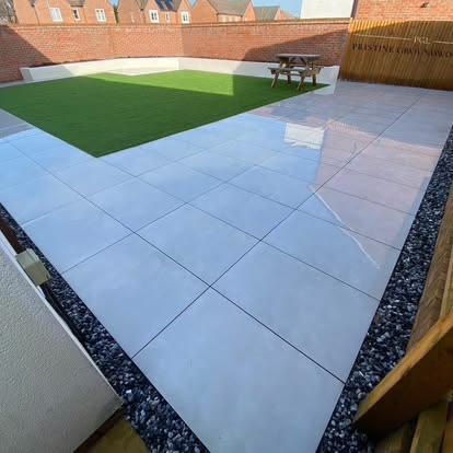 Porcelain patio and artificial lawn in a new build garden