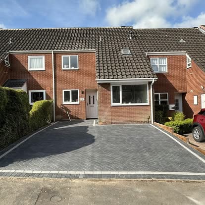 Charcoal block paved driveway outside a terraced house