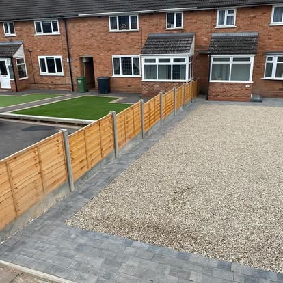 Gravel driveway with new timber fencing and block edging