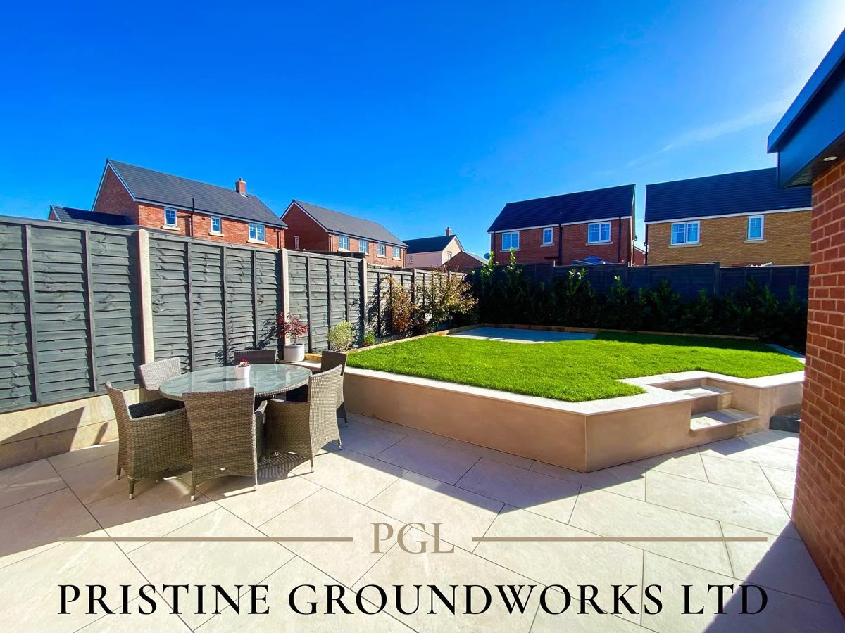 Porcelain patio with an outdoor dining set and raised lawn
