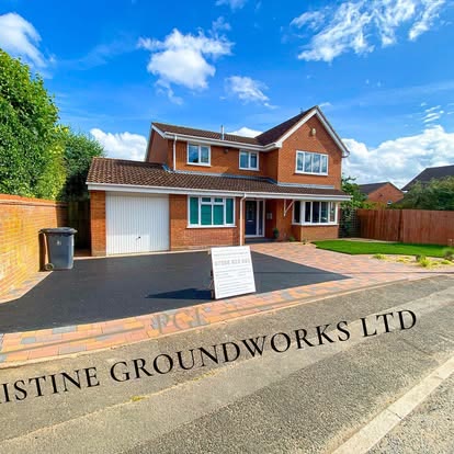 Tarmac driveway with a block border beside a front lawn