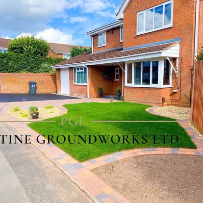 Front lawn with a red block border and new driveway