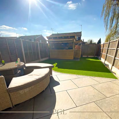 Porcelain patio with outdoor sofa and artificial lawn